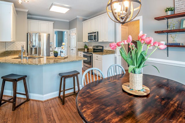 a%20kitchen%20with%20a%20skylight%20and%20a%20chandelier%20over%20a%20dining%20table